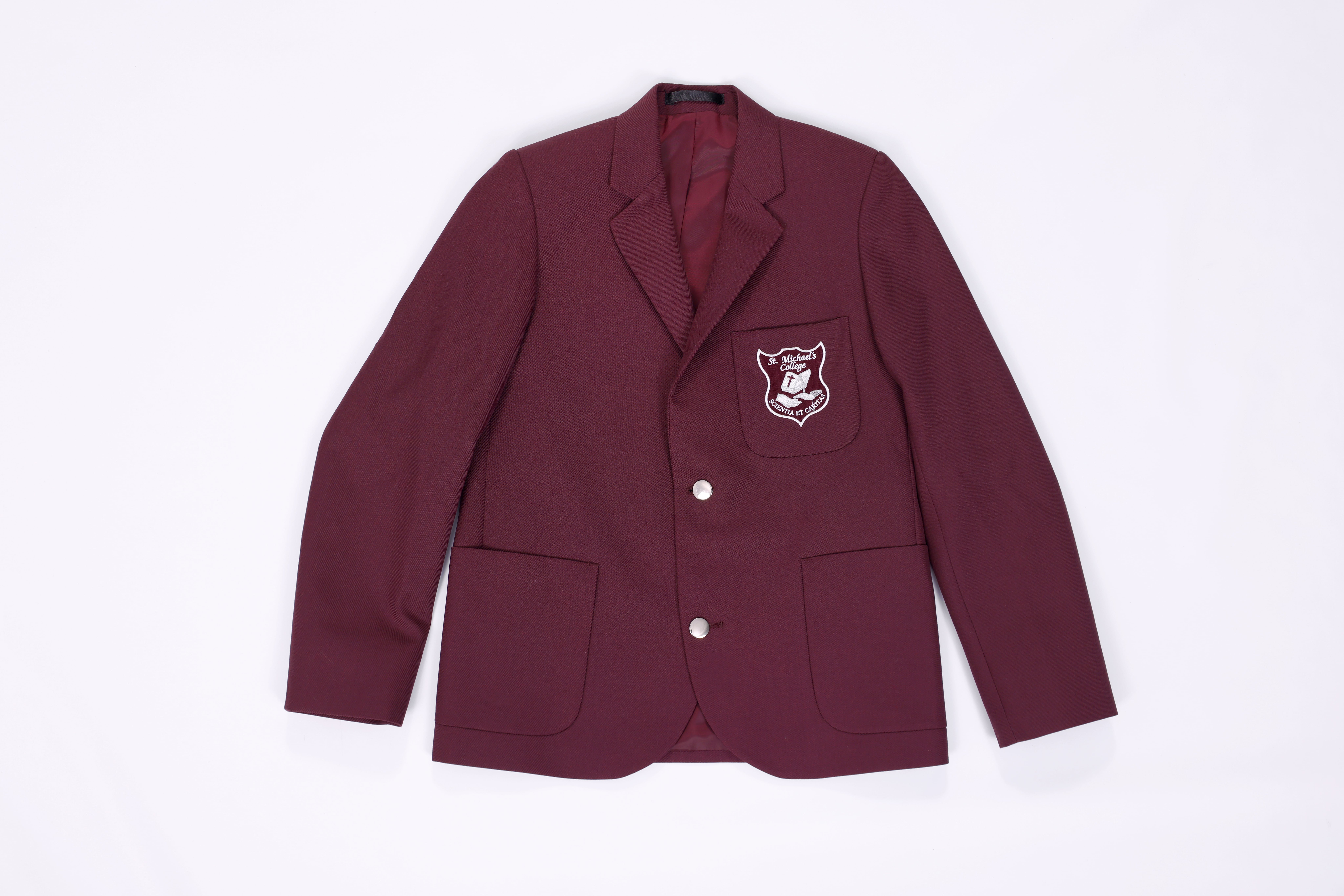 Maroon St Michael’s College blazer with school crest on pocket presented neatly on a plain background